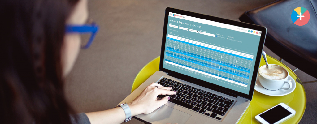 A person using ExpensePlus, a fund accounting software package on a laptop.